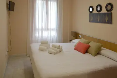 Cama o camas de una habitación en Apartamentos Casa-Patio Las Palmeras
