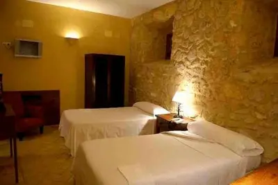 Cama o camas de una habitación en Hospedería del Monasterio