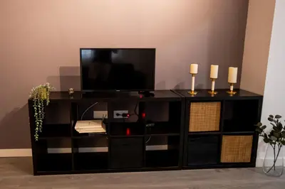 Una televisión o centro de entretenimiento en Apartamentos Doña Concha