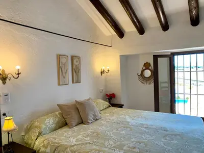 Cama o camas de una habitación en Los Palomos casa rural en el centro de Andalucía
