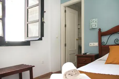 Cama o camas de una habitación en La Piquera Hostal