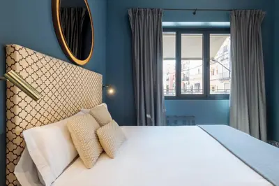 Cama o camas de una habitación en OMM Suites Sevilla