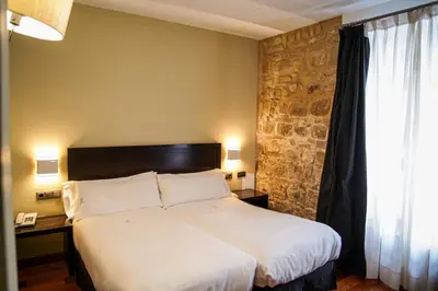 Cama o camas de una habitación en Hotel Baeza Monumental by eme hoteles