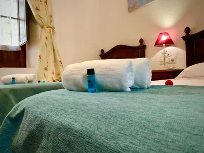 Cama o camas de una habitación en Apartamentos La Casa del Azafrán