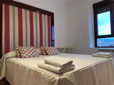 Cama o camas de una habitación en Ático dos dormitorios en el centro de Córdoba