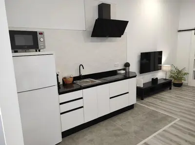 Una cocina o zona de cocina en APARTAMENTO TURISTICO LYRA BAENA
