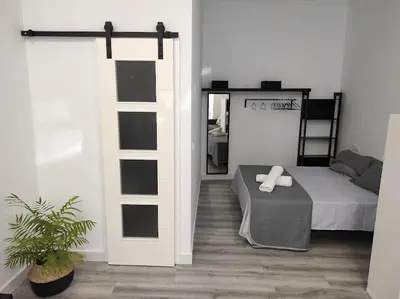 Cama o camas de una habitación en APARTAMENTO TURISTICO LYRA BAENA