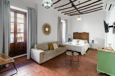Cama o camas de una habitación en La Jⲟya de los Patios - Apartamentos Turísticos