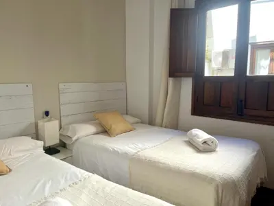 Cama o camas de una habitación en RIBERA SUITE CÓRDOBA