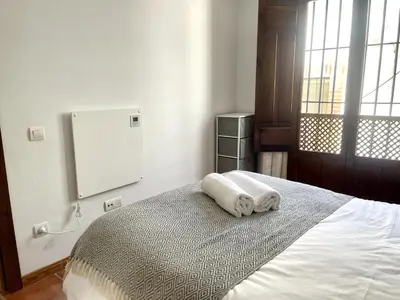 Cama o camas de una habitación en RIBERA SUITE CÓRDOBA