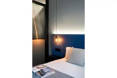 Cama o camas de una habitación en Muralla Sevilla Suites By Lola