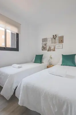 Cama o camas de una habitación en Family HOME SUITS Encantos de Sevilla