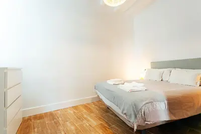 Cama o camas de una habitación en Peral Suite Sevilla
