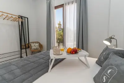 Cama o camas de una habitación en Córdoba Suites Apartments
