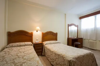 Cama o camas de una habitación en Hotel Riviera