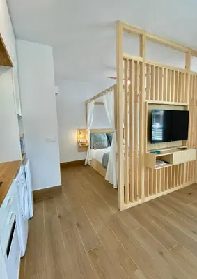 Cama o camas de una habitación en LOFT DELUXE ALMA GARDEN