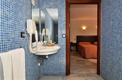 Cama o camas de una habitación en Hotel Averroes