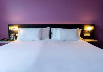 Cama o camas de una habitación en Sercotel Córdoba Medina Azahara