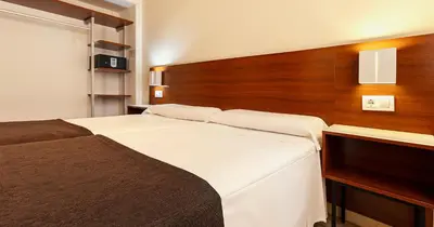 Cama o camas de una habitación en Apartamentos Vértice Bib Rambla