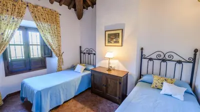 Cama o camas de una habitación en Huerta Nueva Cuevas del Becerro by Ruralidays