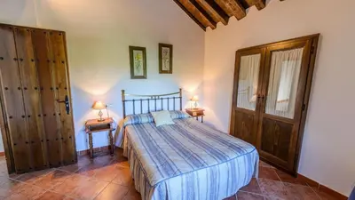 Cama o camas de una habitación en Huerta Nueva Cuevas del Becerro by Ruralidays