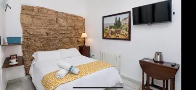 Cama o camas de una habitación en Judería Suites