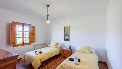 Cama o camas de una habitación en Huerta Abuela María Archidona by Ruralidays