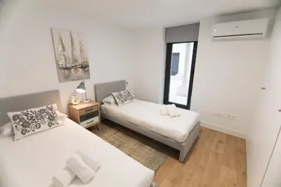 Cama o camas de una habitación en RentalSevilla San Esteban