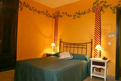 Cama o camas de una habitación en Hotel Las Rosas